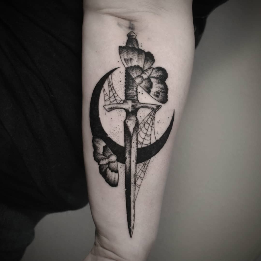 Black crescent moon with a dagger and moths. (Source: @arcanetraditions)
