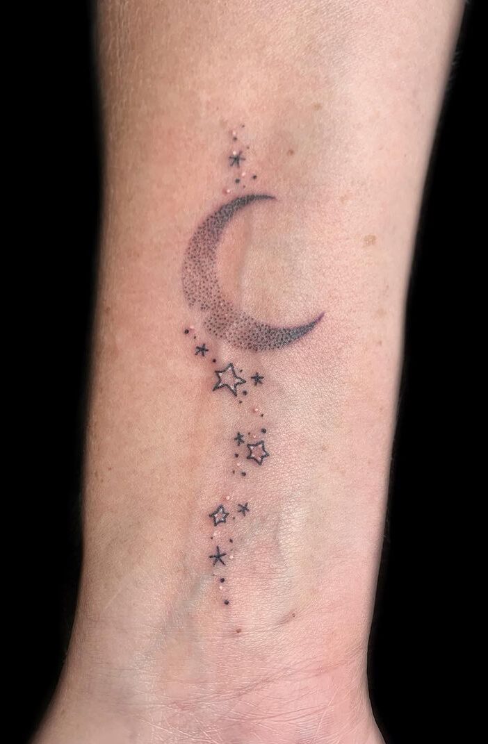 Dotwork moon and stars wrist tattoo. (Source: @wildbonestattoos)