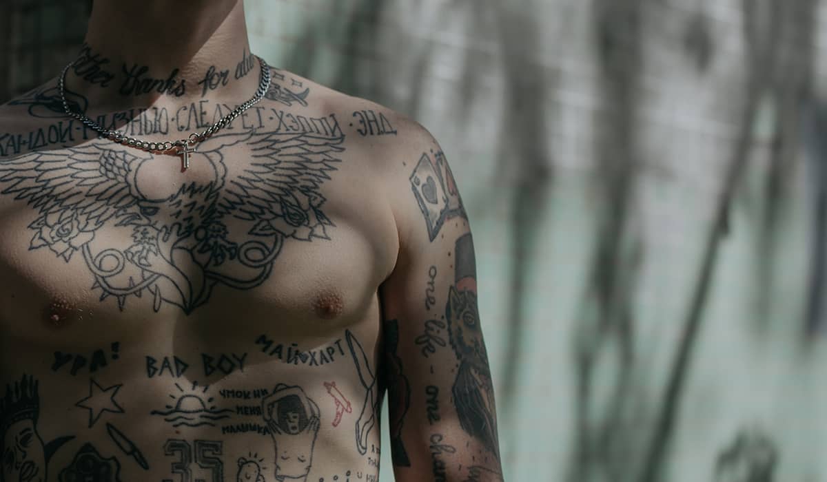 Man with a variety of black and white tattoos.