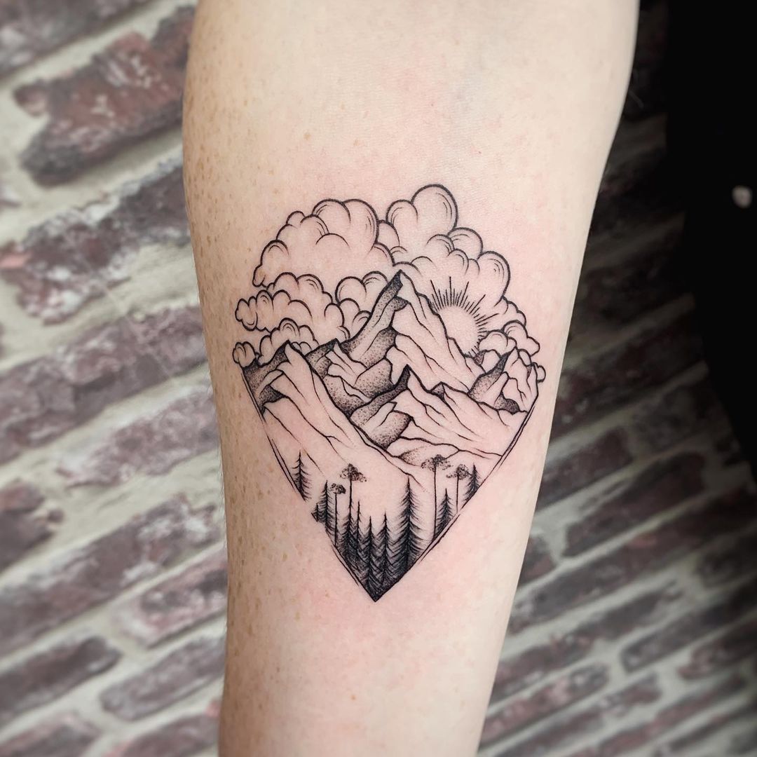 Mountains with clouds tattoo.
