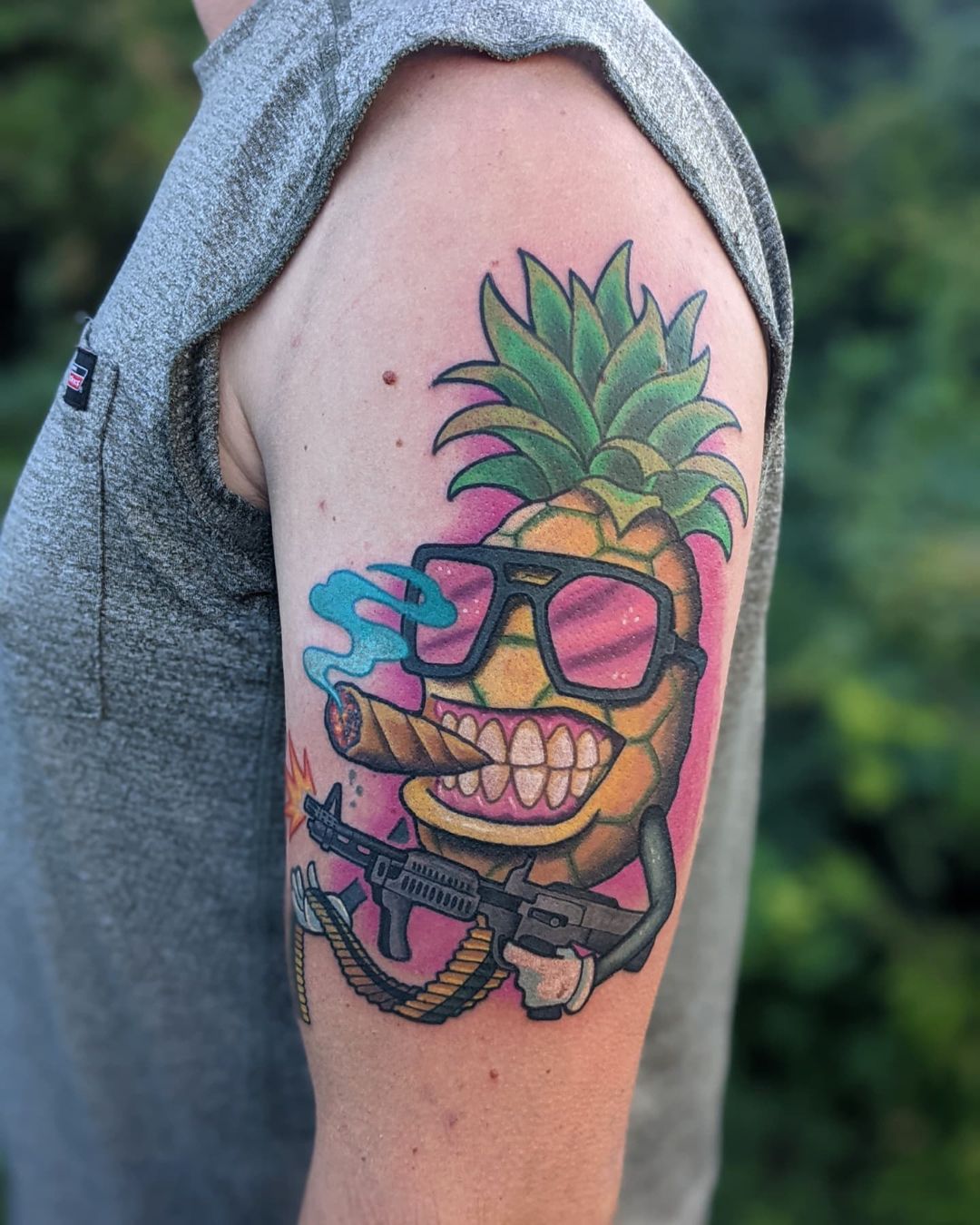 Machine gun toting pineapple tattoo by @zackindertattoos